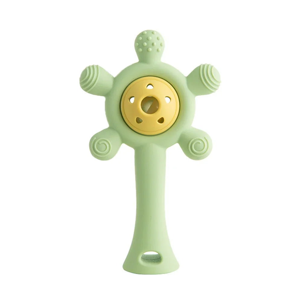 Green silicone baby teething toy with rattle for soothing sore gums during the teething stage.