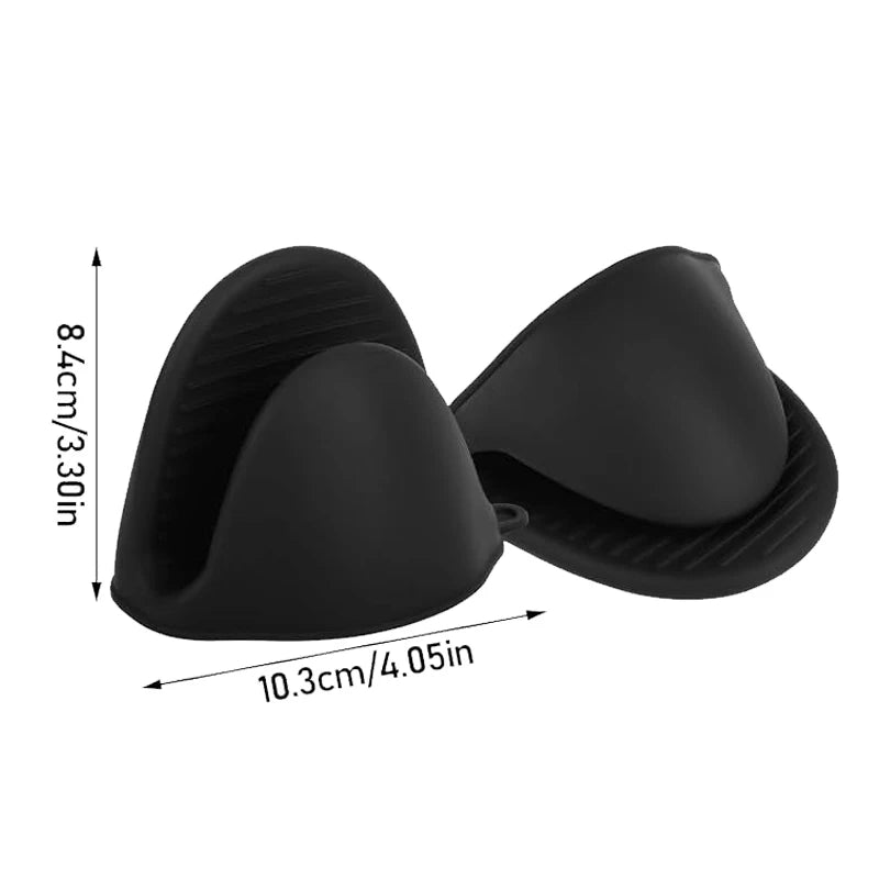 Black silicone air fryer egg cup mold pair with scalloped edges.