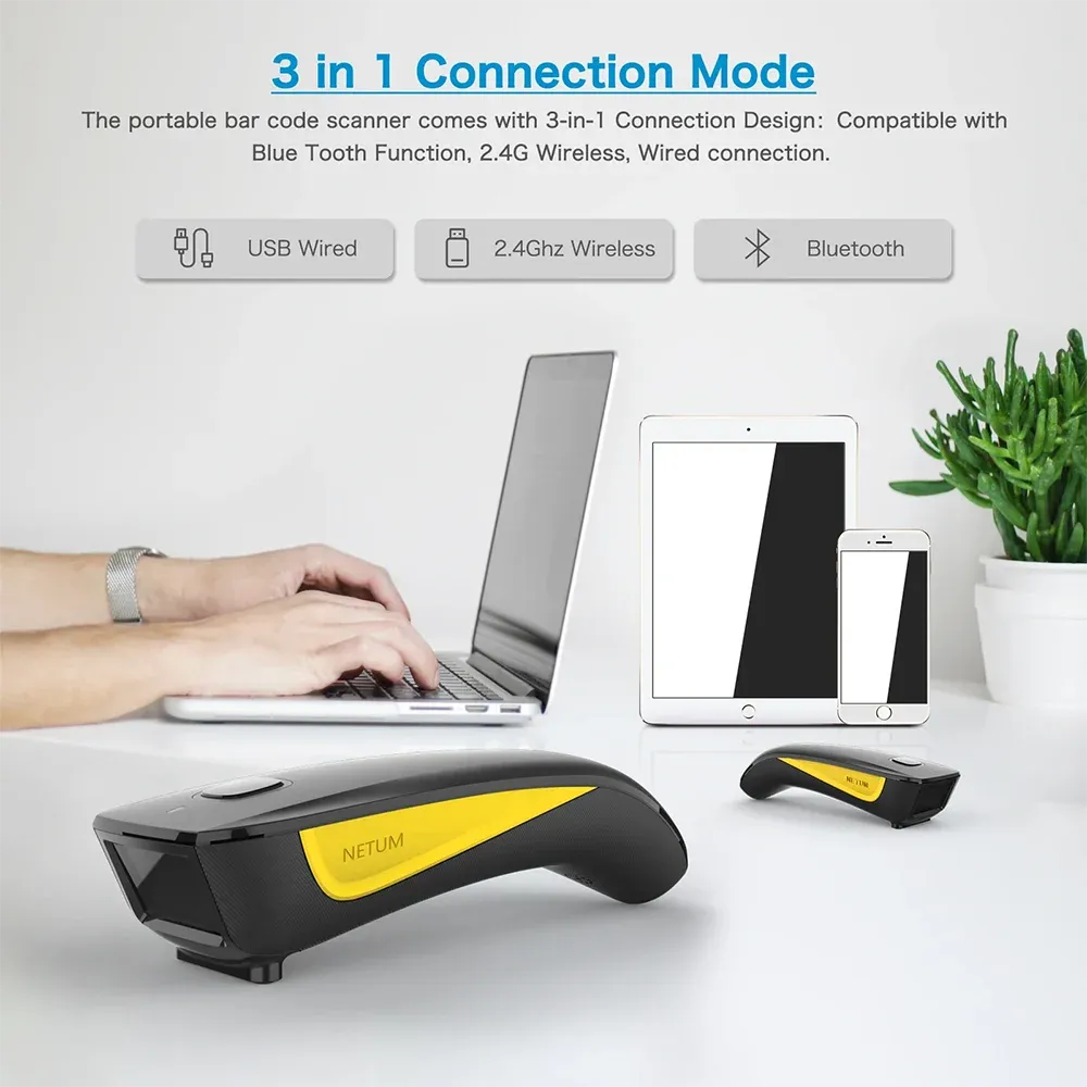 Handheld 2D barcode scanner with yellow accent held near a laptop
