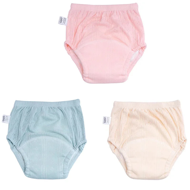 Three-pack of baby cotton training diaper pants in pink, blue, and yellow with textured knit design.