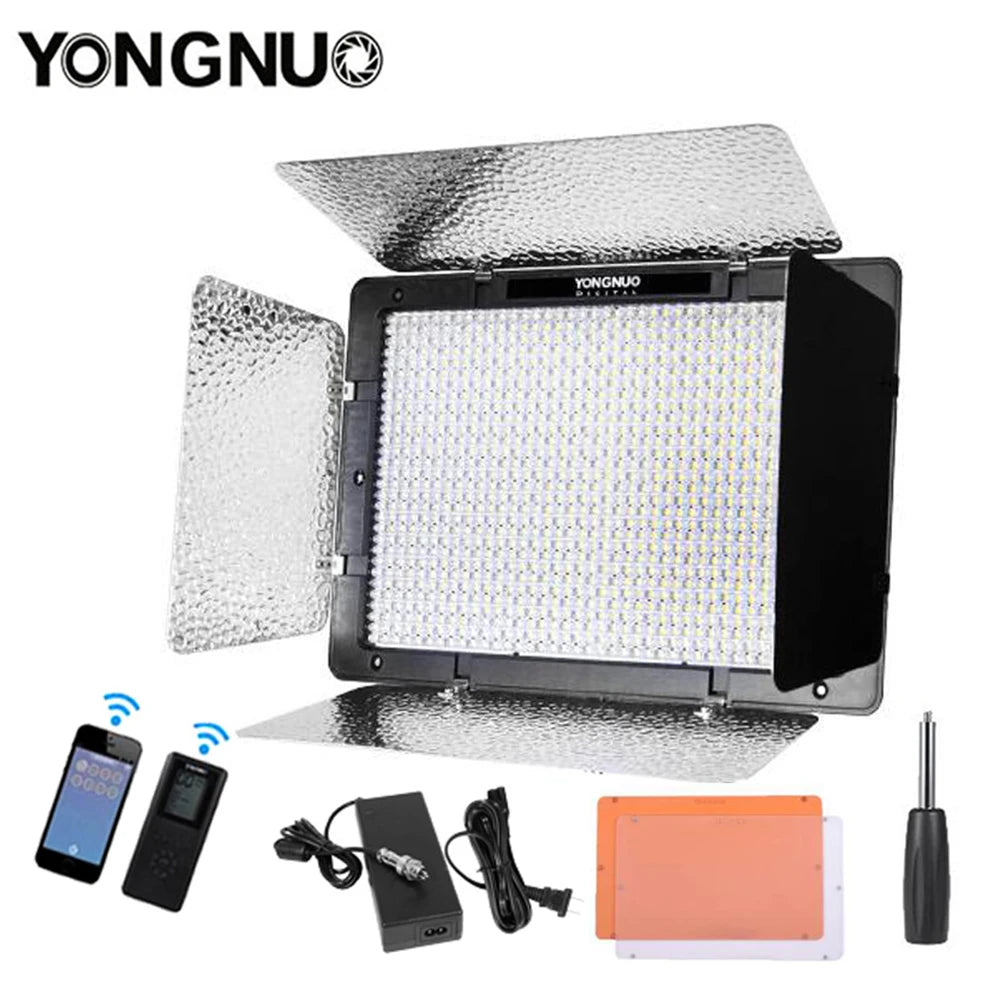 Rectangular LED video light with reflective silver barn doors, power adapter, remote controls, filters, and light stand.