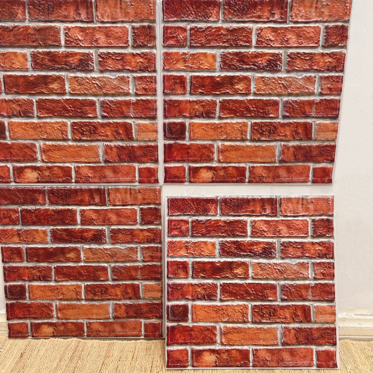 Peel-and-stick backsplash tile sheet with red brick pattern and distressed texture