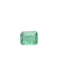 Loose emerald-cut green gemstone with step facets, octagon outline, on white felt