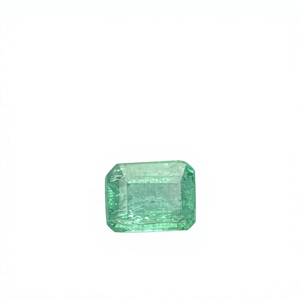 Loose emerald-cut green gemstone with step facets, octagon outline, on white felt