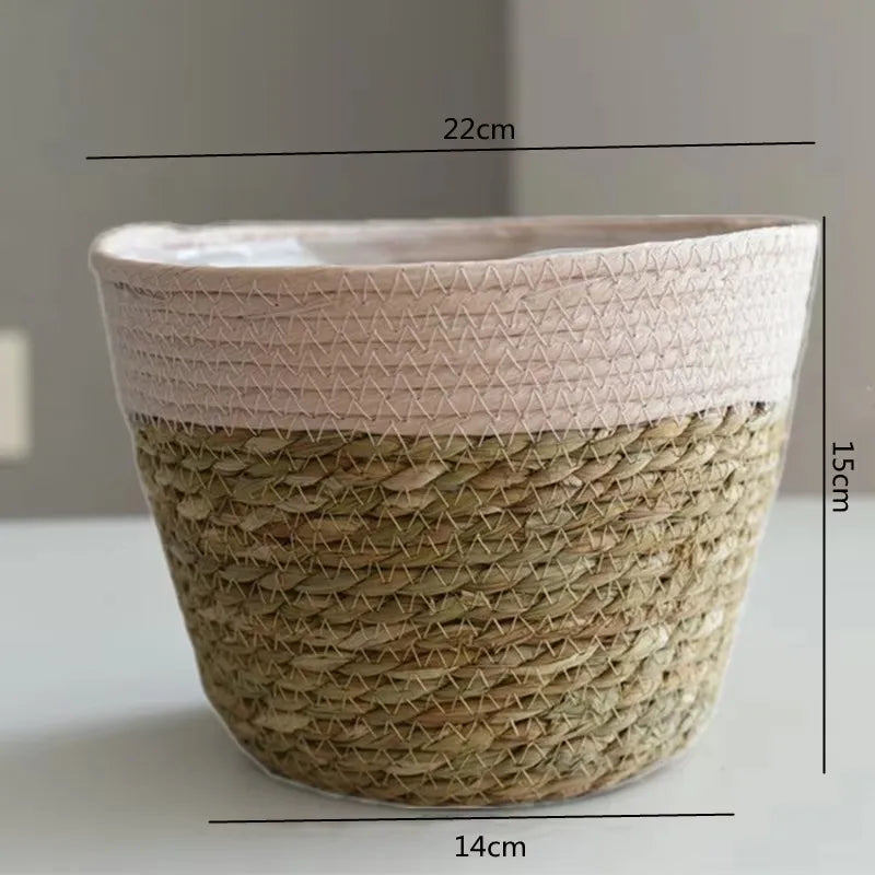 Woven grass planter basket with white top lining and tan base, 14cm wide, open.