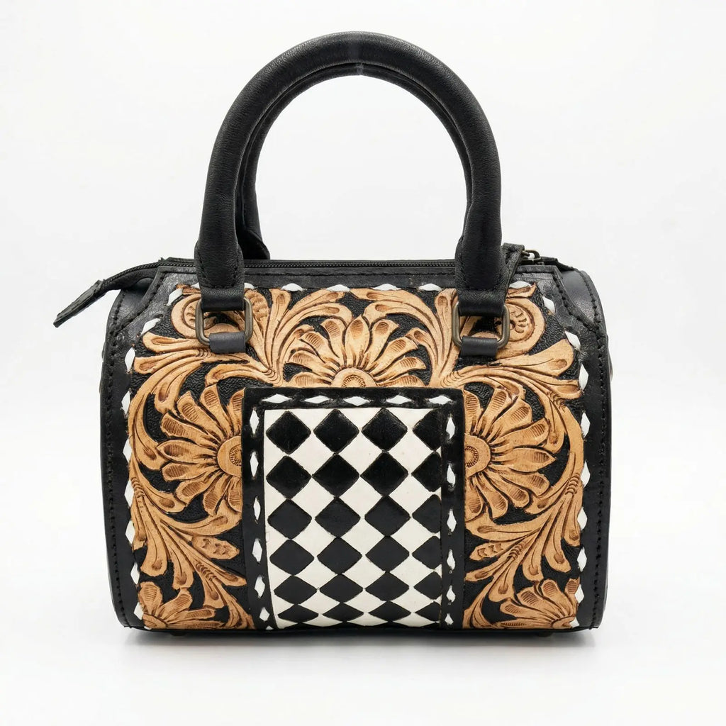 Luxury genuine leather travel trunk bag with hand-tooled floral carving and black and white checkered inlay pattern.