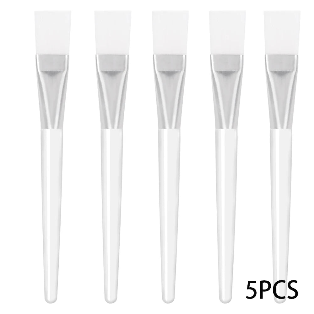 Five white facial mask applicator brushes with soft synthetic bristles, silver ferrules, and plastic handles.
