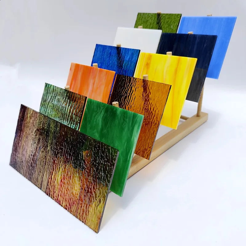 Set of 12 textured transparent stained glass mosaic tiles, multicolor on wooden rack