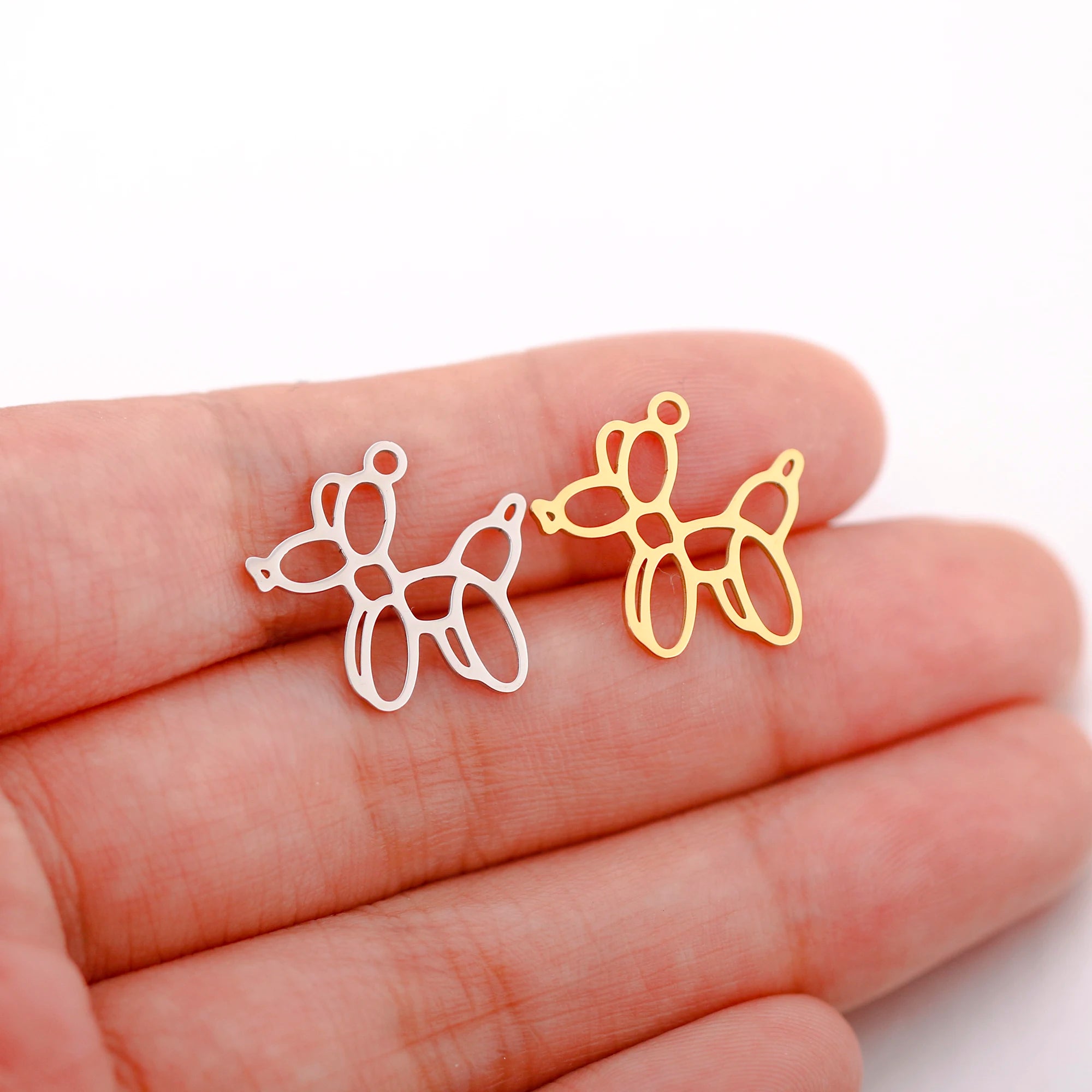 Silver and gold stainless steel balloon dog charms for DIY jewelry making, necklaces, and bracelets.