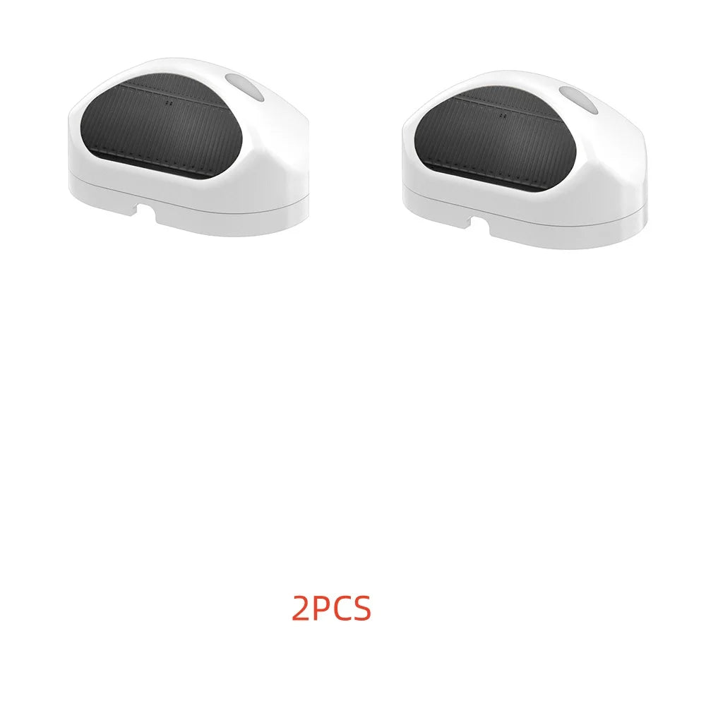 Two white rain sensors together, each with a black detection window