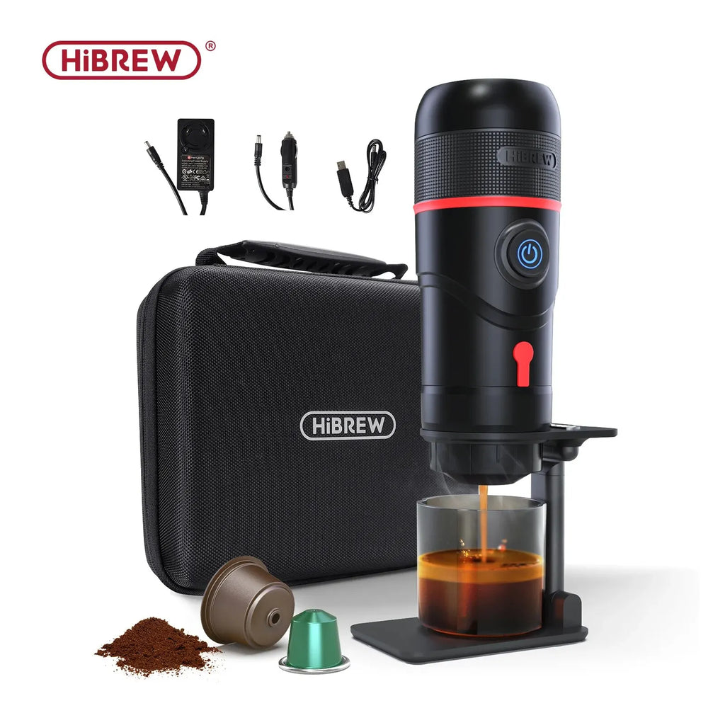 HiBREW portable espresso maker in black with travel case, power cords, and capsules, brewing coffee into a glass.