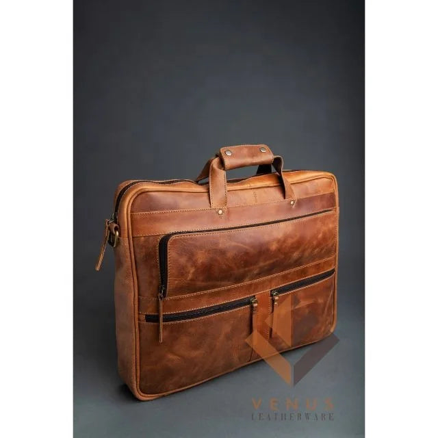 Tan genuine leather business briefcase with dual front zip pockets, top handles, and professional designer style.