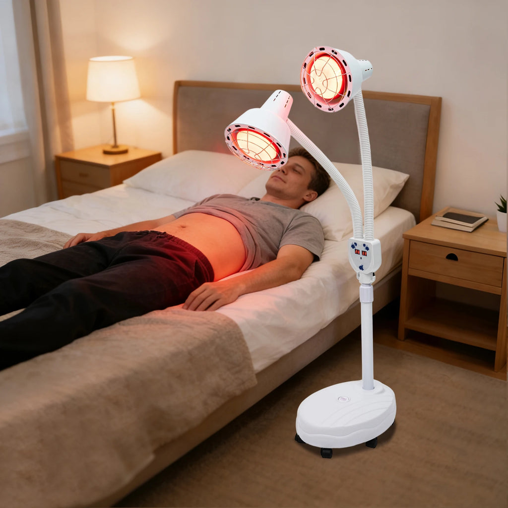 Double-headed 275W infrared heat lamp with adjustable stand for pain relief, used by a man lying on a bed.