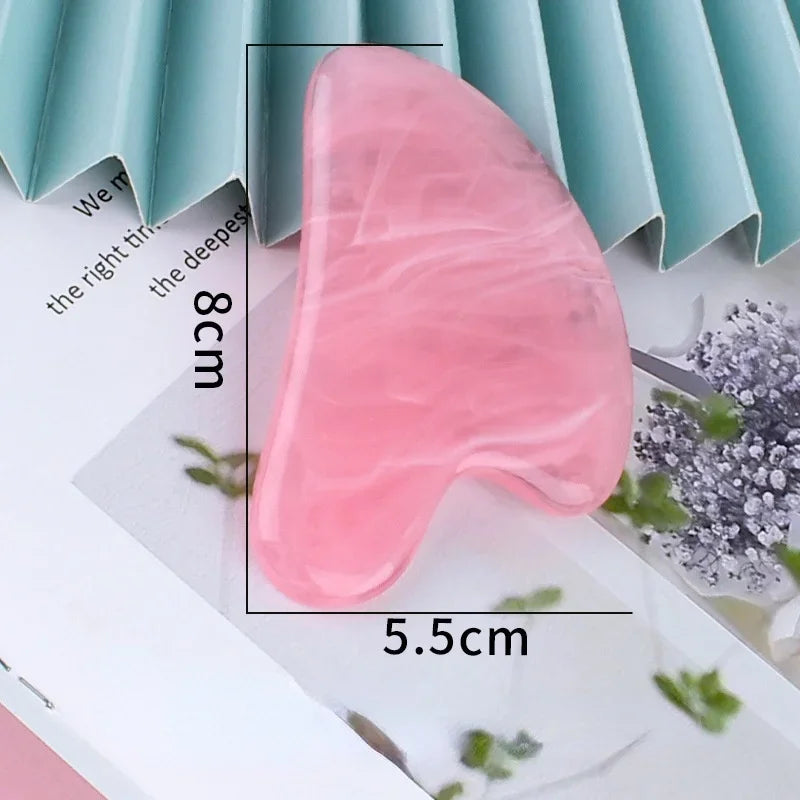 Pink heart-shaped resin gua sha massage tool with white marble-like veins, showing height and width dimensions.