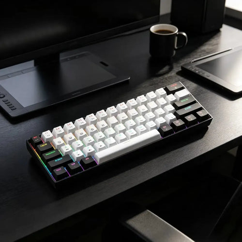 Compact 61-key mechanical gaming keyboard with RGB backlighting, white and black keycaps, on a dark desk setup.