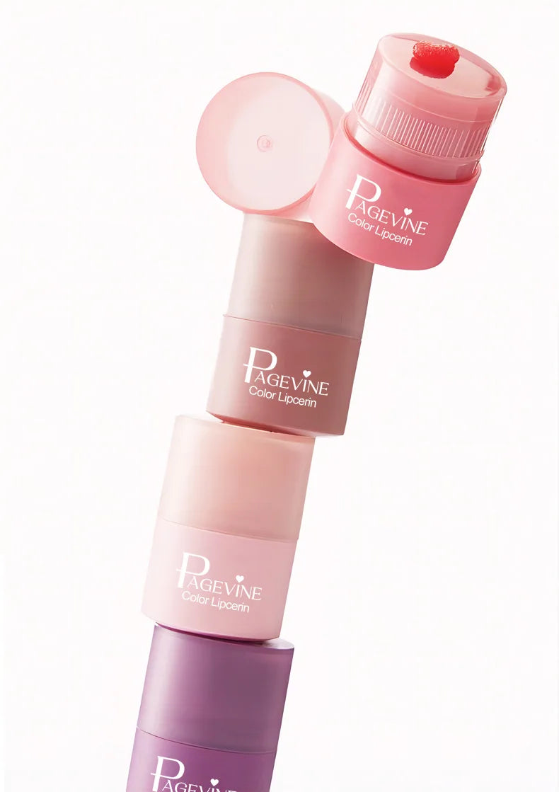 Stack of hydrating twist-up lip balms in various pink shades, featuring a non-sticky, moisturizing lip oil texture.