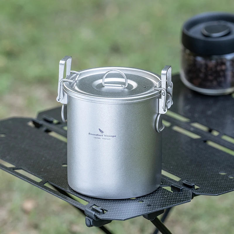 Titanium rice cooker pot with domed lid on a camping stove burner