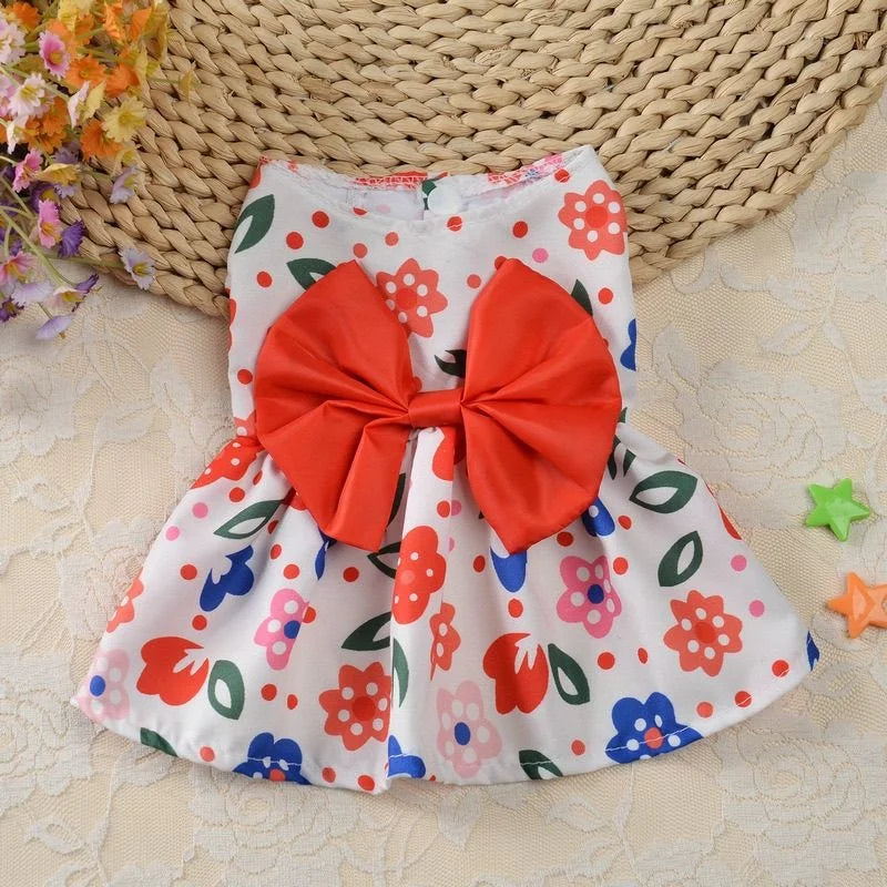 Cute floral spring dog dress with a large red bow for small puppies, perfect for summer pet fashion.