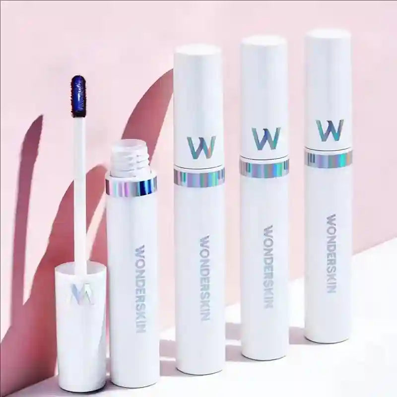 Wonderskin peel-off tattoo lip gloss tubes with applicator, featuring brown matte lip tint in elegant white packaging.