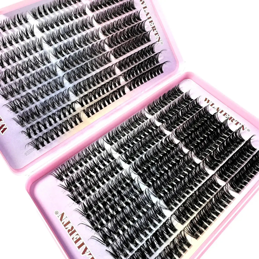Black individual cluster lashes in a pink storage case for professional eyelash extensions.