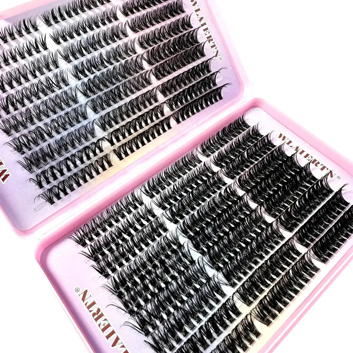 Individual black false eyelash clusters arranged in a two-part pink storage tray for eye makeup application.