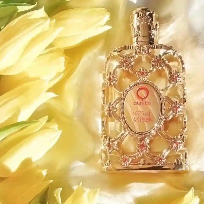Orientica Royal Amber 100ml EDP: Luxurious unisex amber fragrance in an ornate, gold filigree bottle with floral décor.