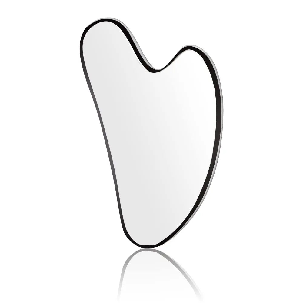 A heart-shaped, smooth silver stainless steel gua sha tool isolated on a white background with a soft reflection below.