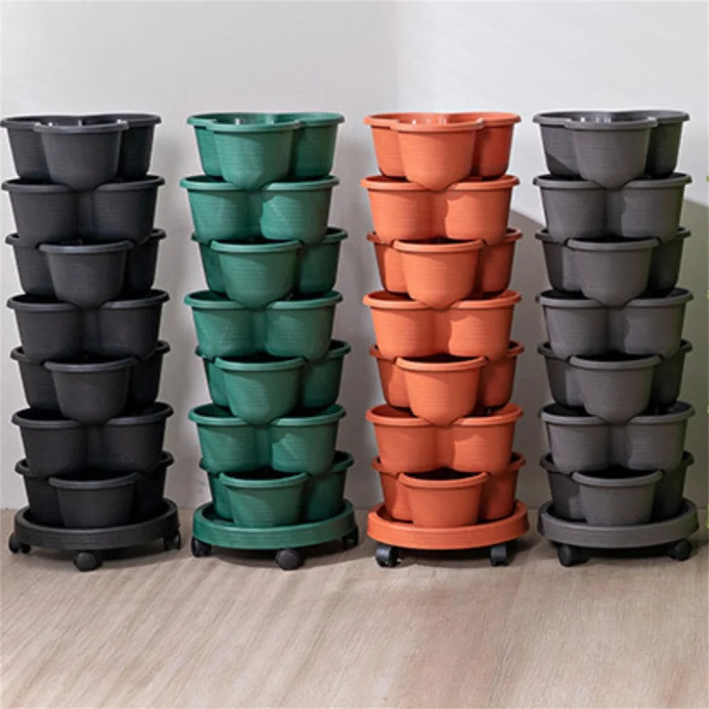 Set of stackable vertical garden planters in dark, green, orange, and gray, all on wheels.