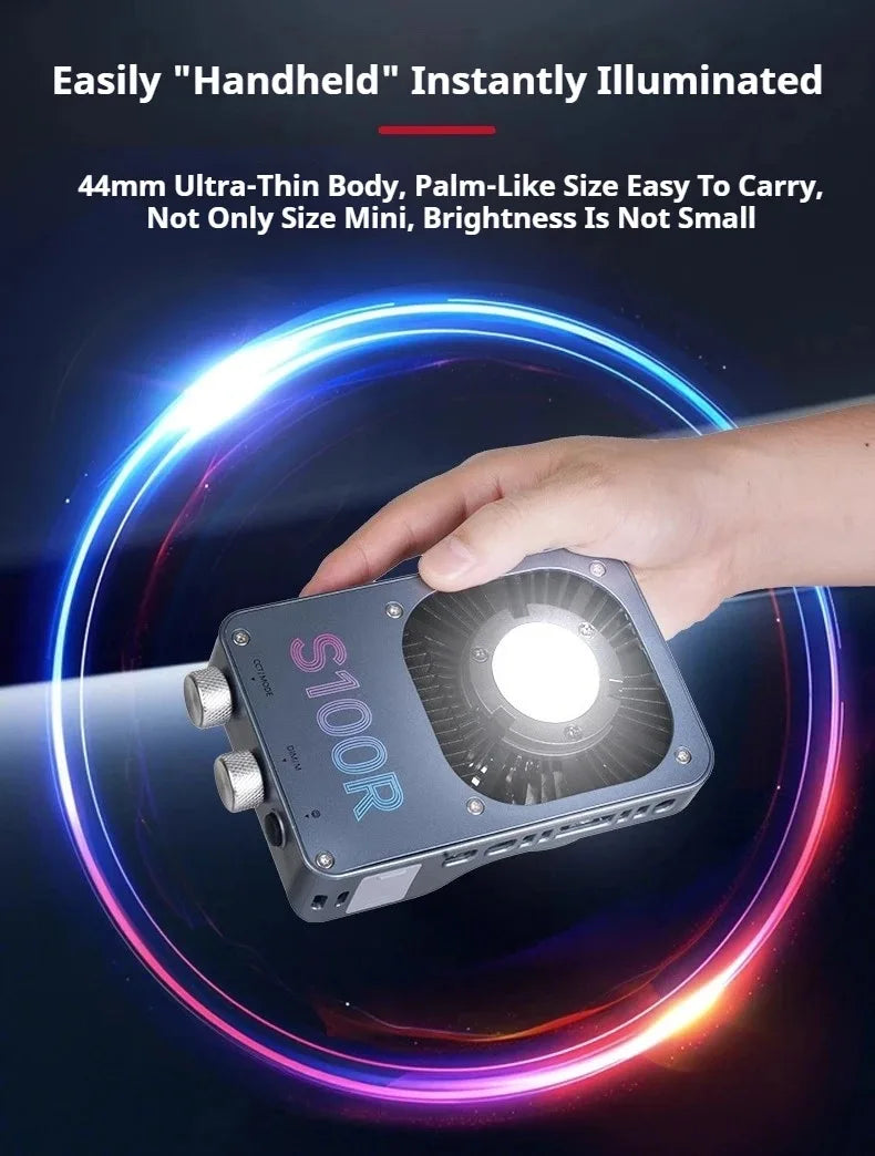 S100R palm-sized grey handheld LED light with two adjustment knobs, being held to illuminate a scene.