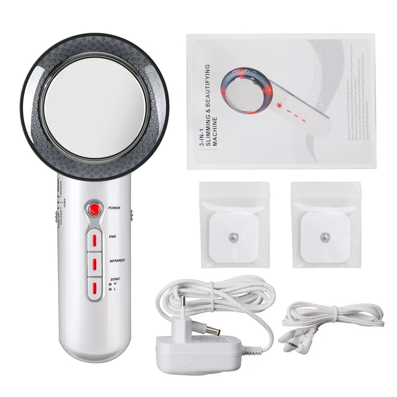 White and black 3-in-1 handheld slimming device with EMS pads, power adapter, and user manual.