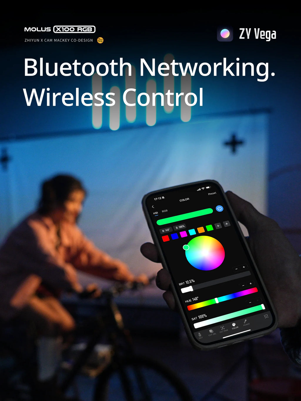 Hand holding smartphone displaying the ZY Vega app interface for adjusting color and light settings wirelessly.
