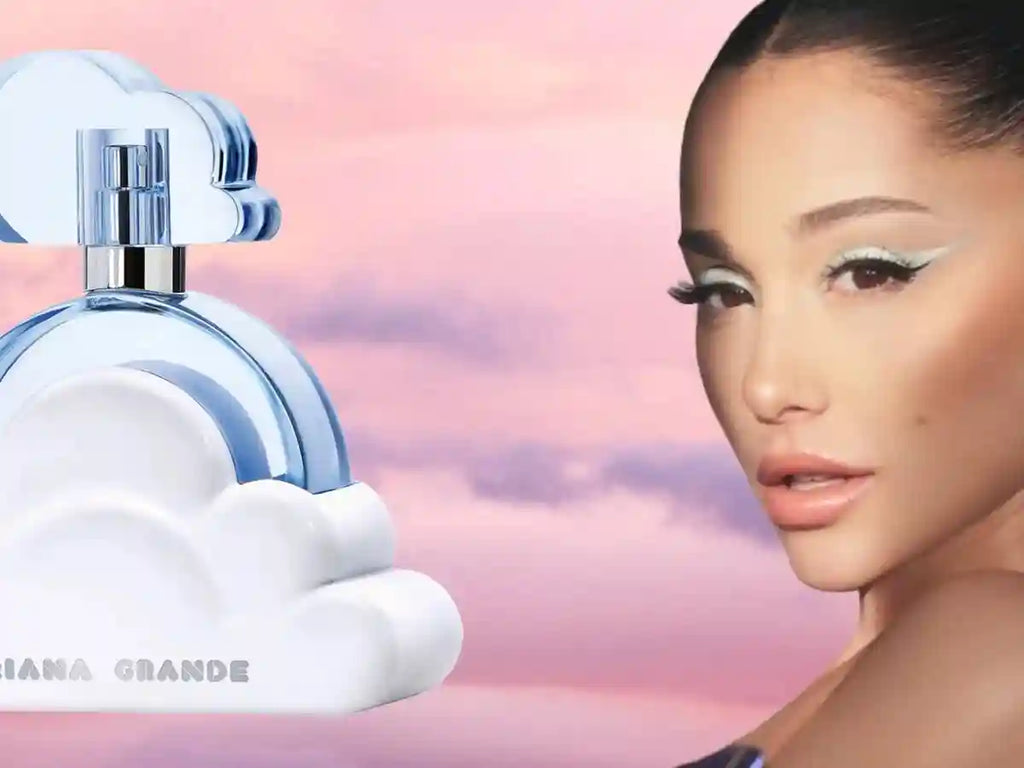 Cloud Eau de Parfum in a white, cloud-shaped glass bottle with blue accents, against a sunset sky background.