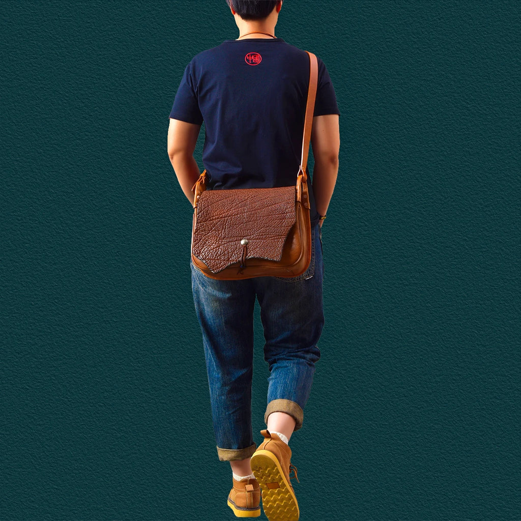 Vintage brown genuine cowhide messenger bag with textured flap, handmade artisan shoulder bag for casual travel.