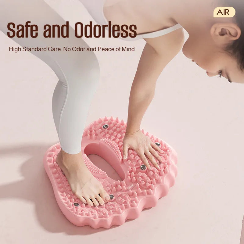Person using a pink, heart-shaped inflatable acupoint massage mat with magnetic stone nodes for foot care.