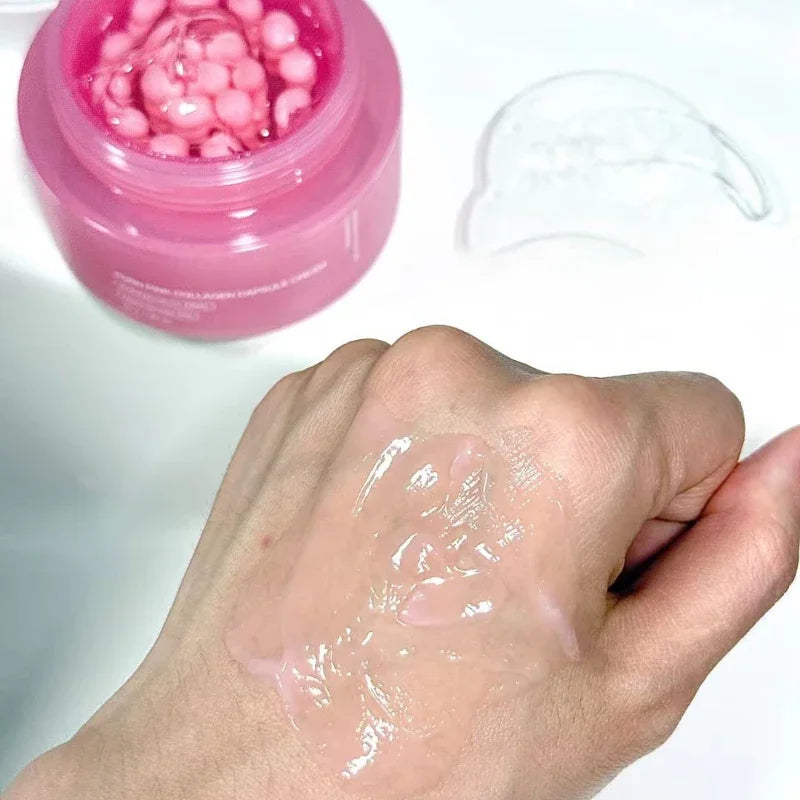 Pink jar filled with pink collagen capsules next to a hand testing the light, clear pink gel cream texture.