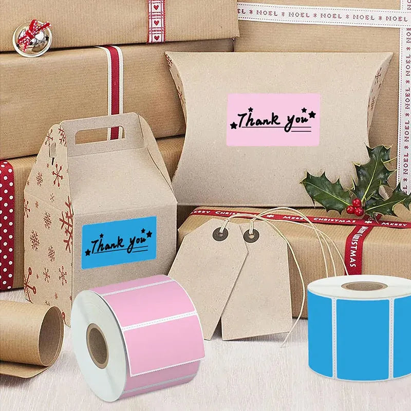 Thermal label sticker rolls with printed label tags on gift and parcel boxes