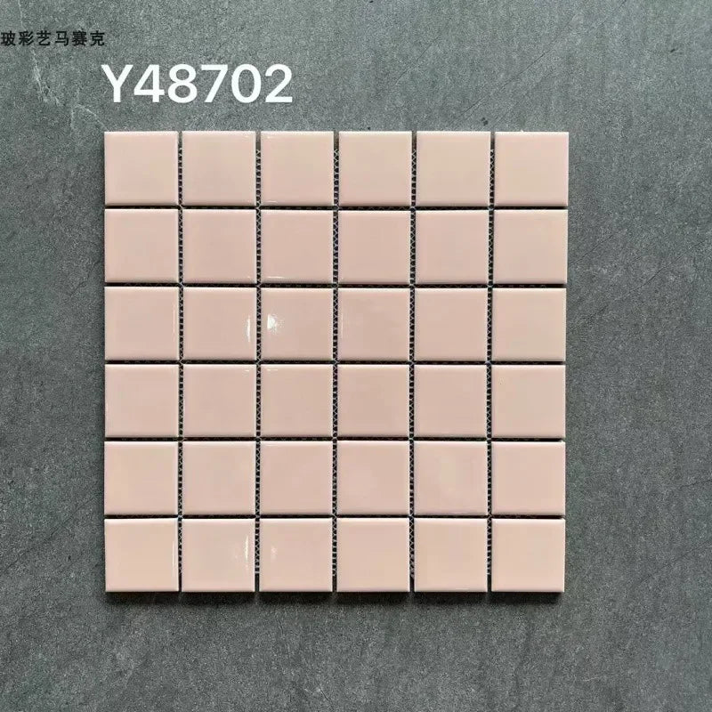 Ceramic mosaic tile sheet with blush pink squares and dark grout lines