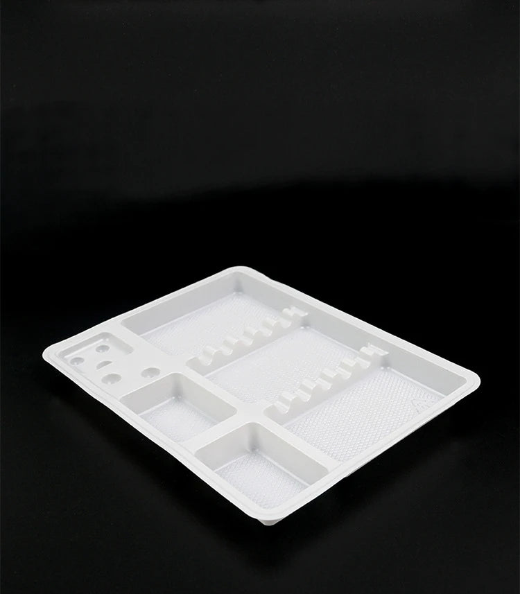 White plastic rectangular partitioned tray with textured base, used for organizing small parts or hardware components.
