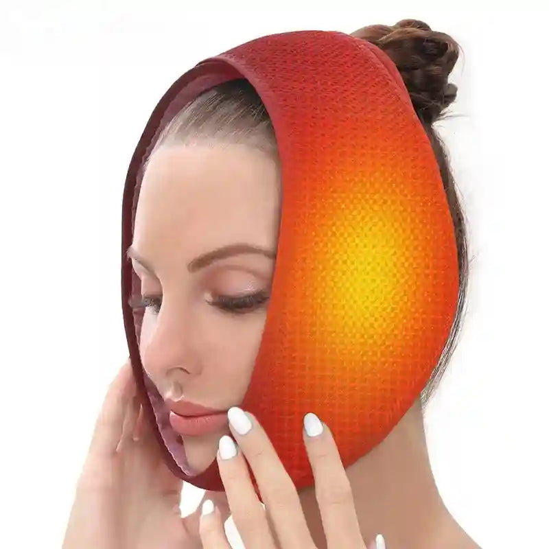 A woman wears a curved, red, textured electric heated chin and jaw wrap, holding it in place with both hands.