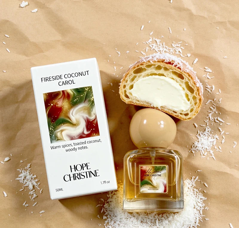 Fireside Coconut Carol 50ml perfume in a square glass bottle with a round beige cap, next to its white packaging box.