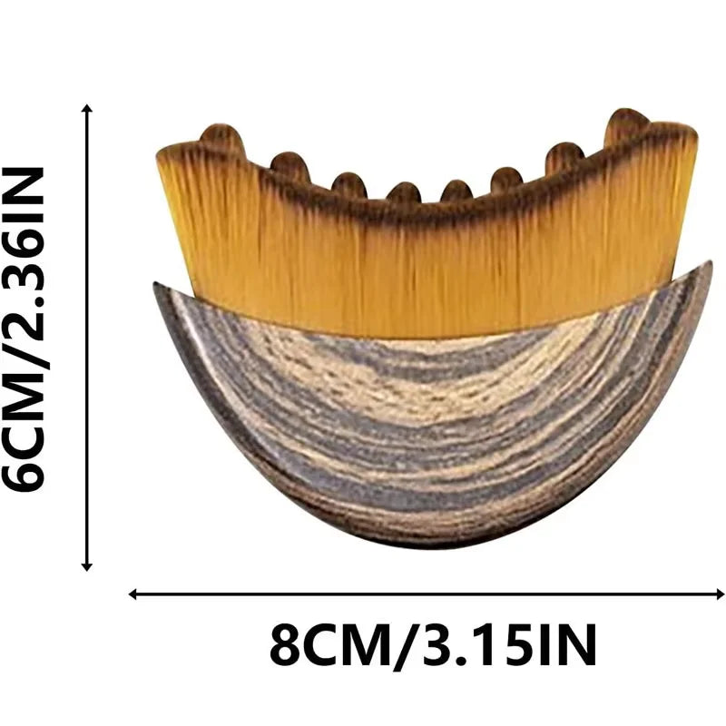 Crescent-shaped lymphatic contour face brush with a wood-grain handle and soft, dense yellow bristles. 6cm x 8cm.