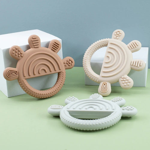 Brown, beige, and sage silicone baby teething rings for soothing teething relief.