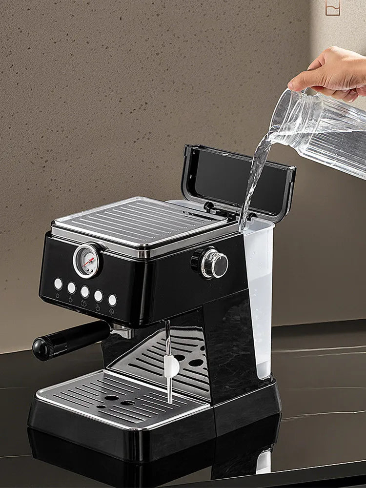 Black modern espresso machine with pressure gauge, chrome accents, and detachable water tank being filled with water.