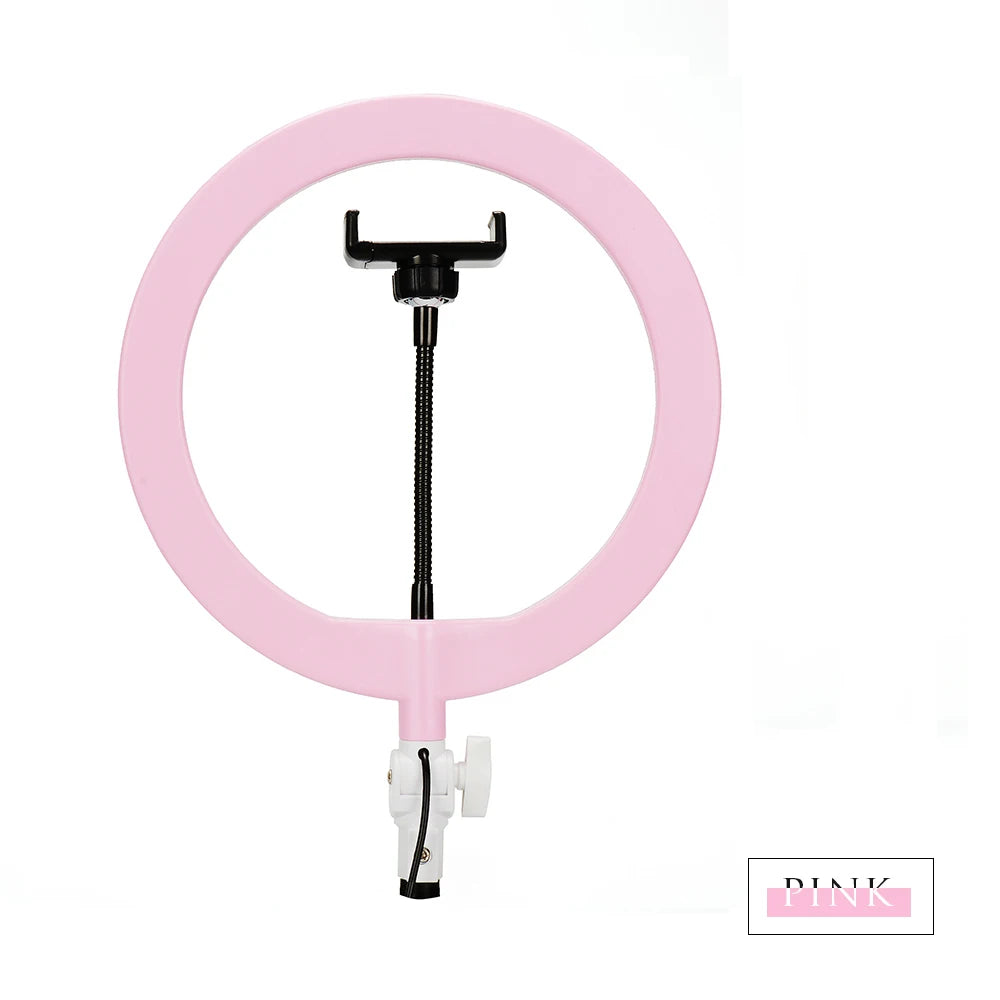 Pink ring light with a flexible black phone holder mount for content creation and photography.