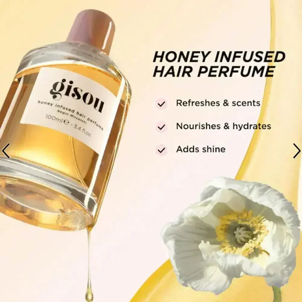 Gisou honey-infused hair perfume bottle in a clear glass container with gold liquid, elegant floral background.