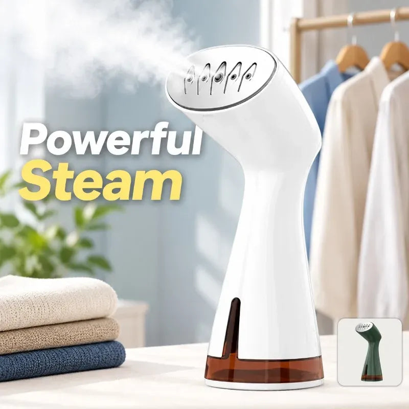 Handheld garment steamer releasing powerful steam with folded clothes and hanging shirts nearby.