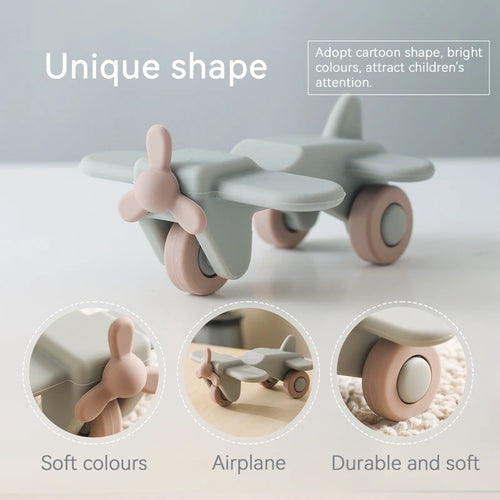 Sage green and dusty pink airplane silicone teething toy for baby teething relief.