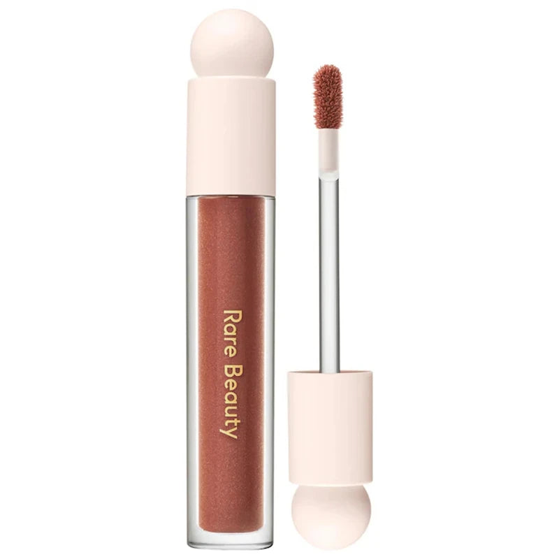 Rare Beauty Soft Pinch Tinted Lip Oil with doe-foot applicator in a moisturizing, glossy mauve-brown formula.