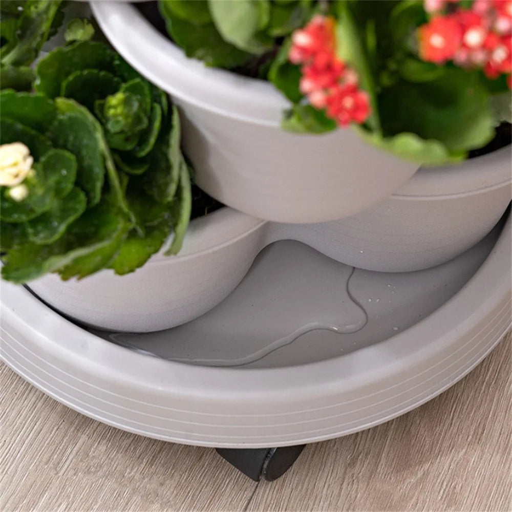 Stackable vertical garden planter base with wheels and drainage openings, gray plastic construction.