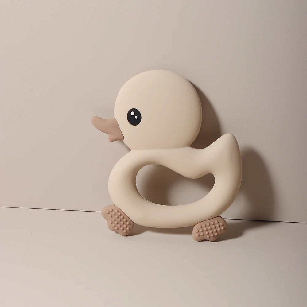 Beige silicone duck baby teething toy for soothing sore gums.